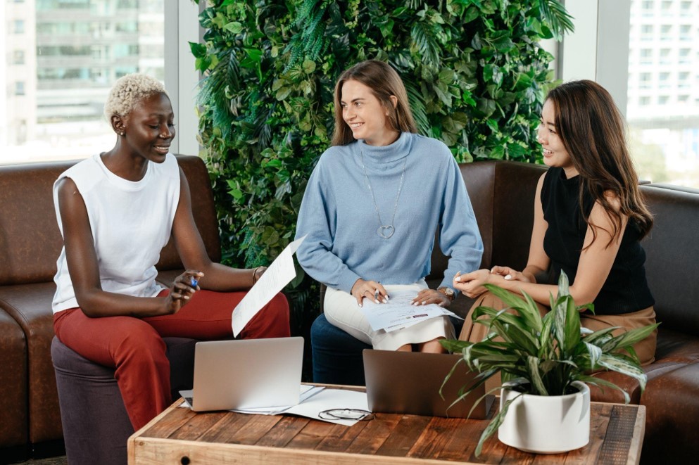 Three young ladies in discussion