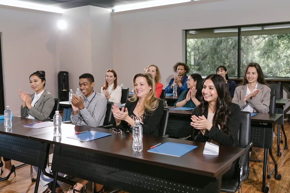 Adult students clapping