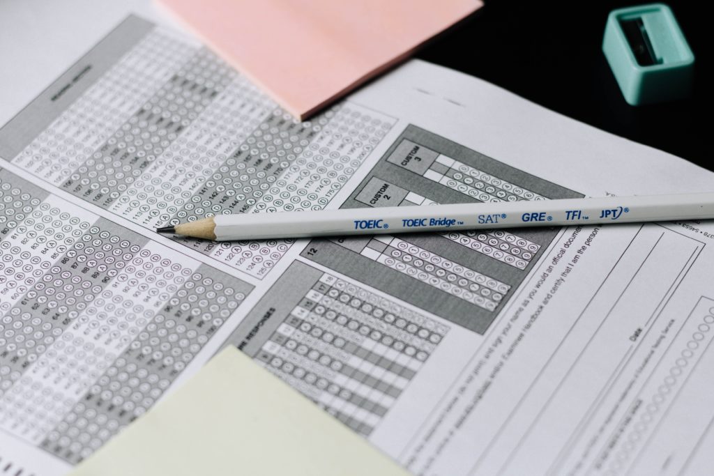 White pencil on top of standardized test sheet.