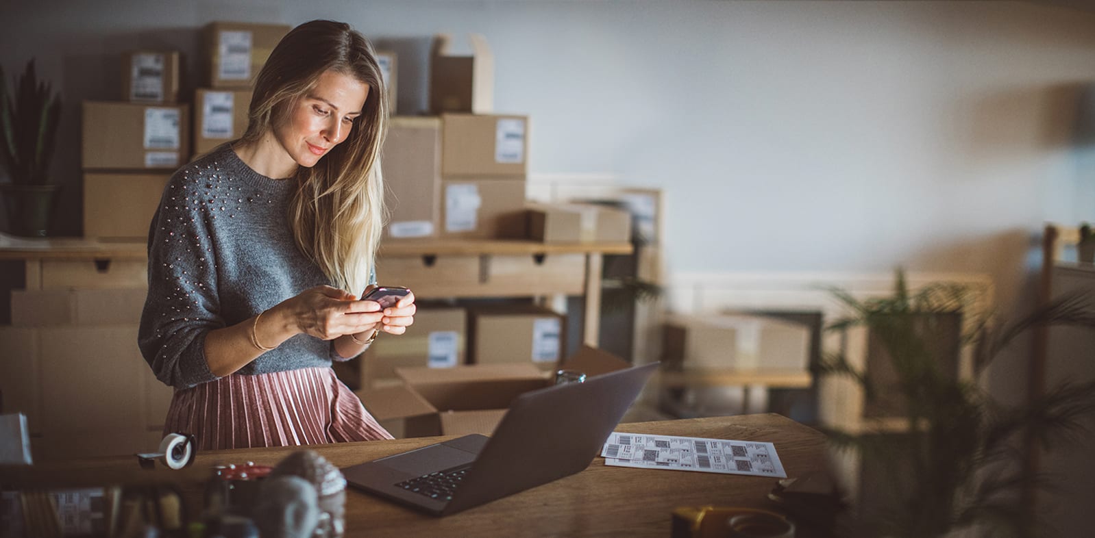 female with smartphone and computer