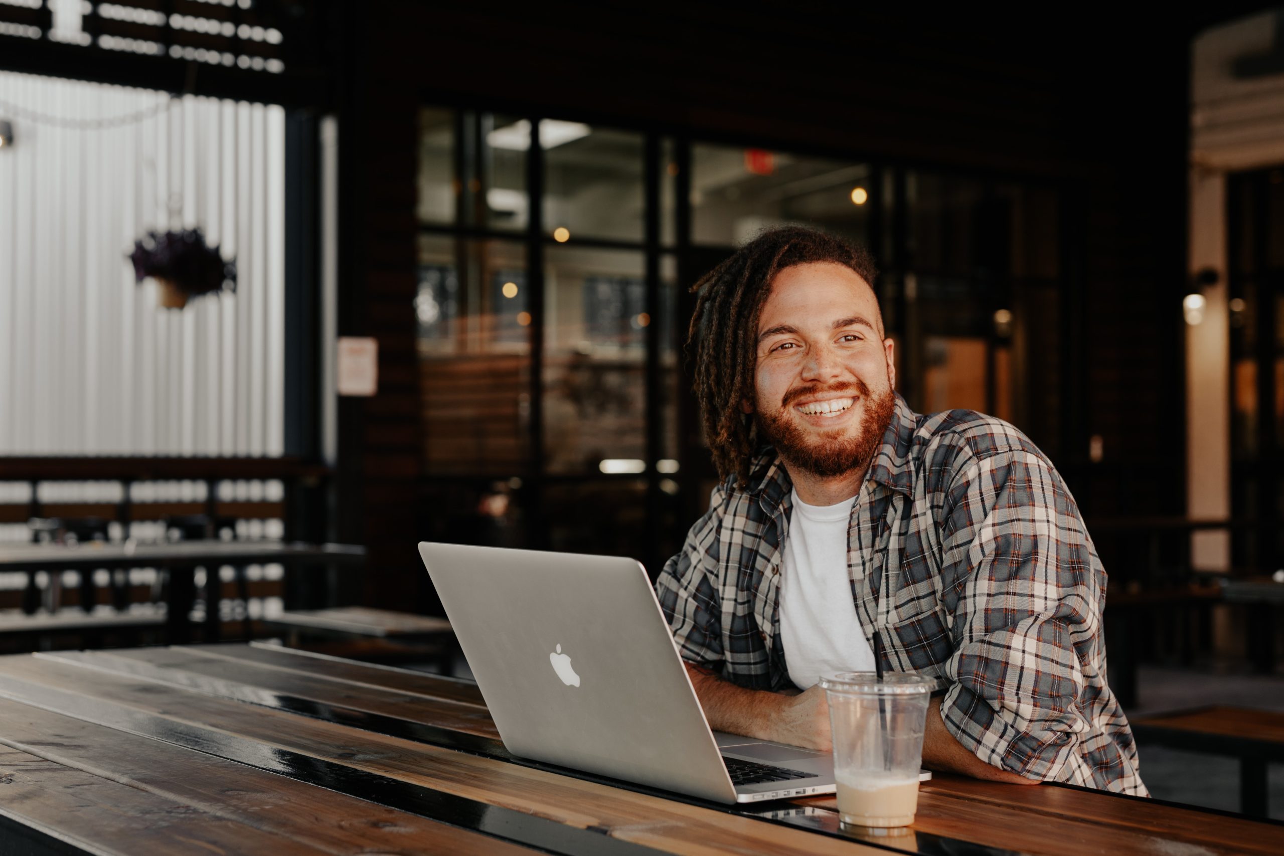 Man smiling while working at his laptop.