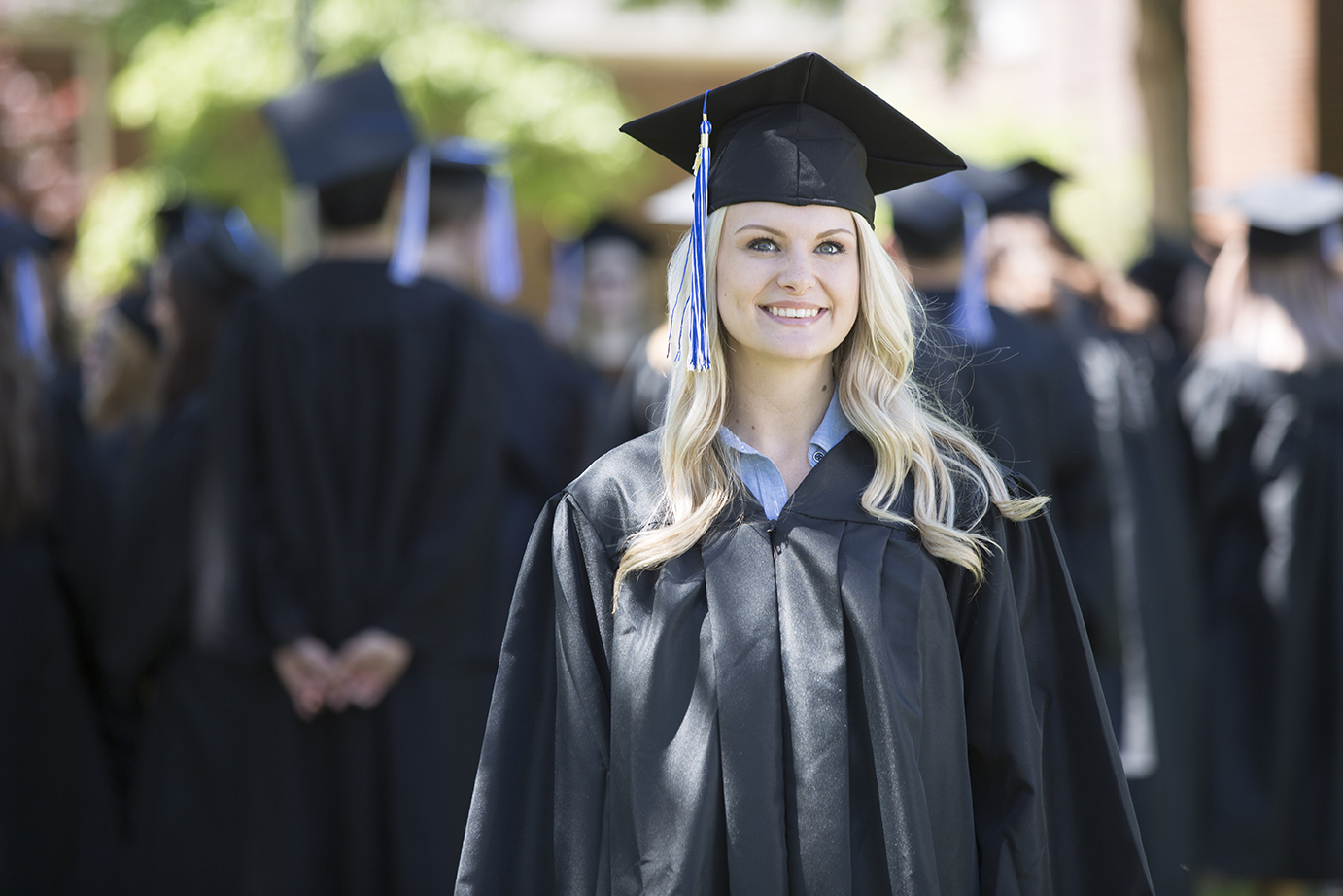 Graduate in cap and gown at graduation