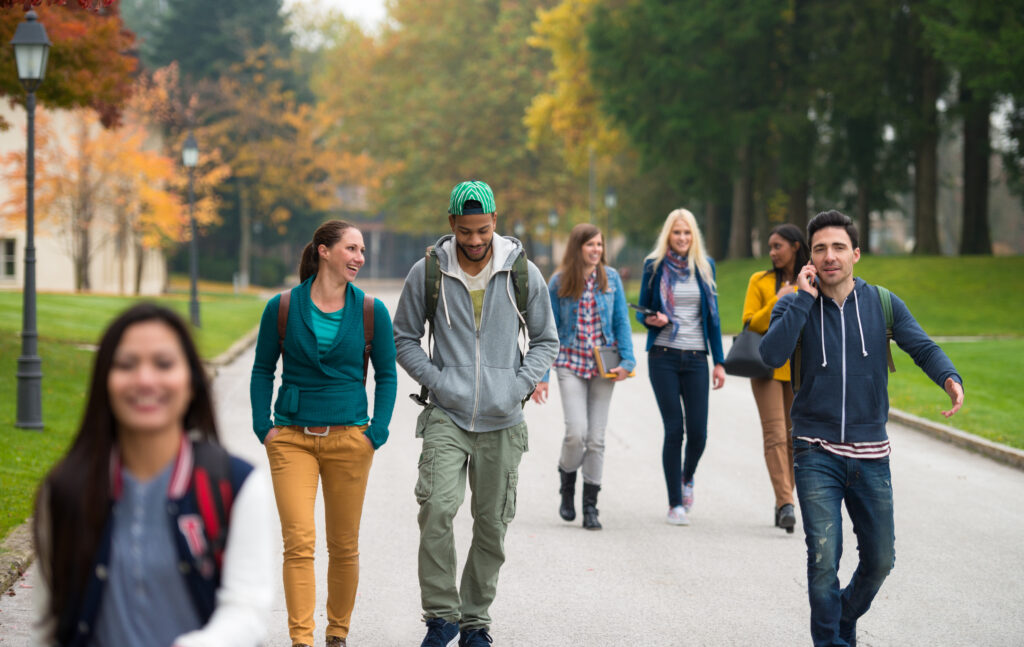 College Students Walking Through The Park
