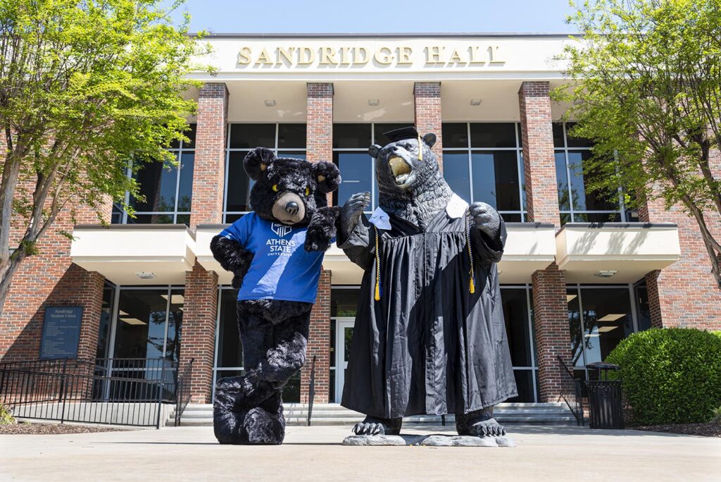 Hebrew the Bear posing with his statue