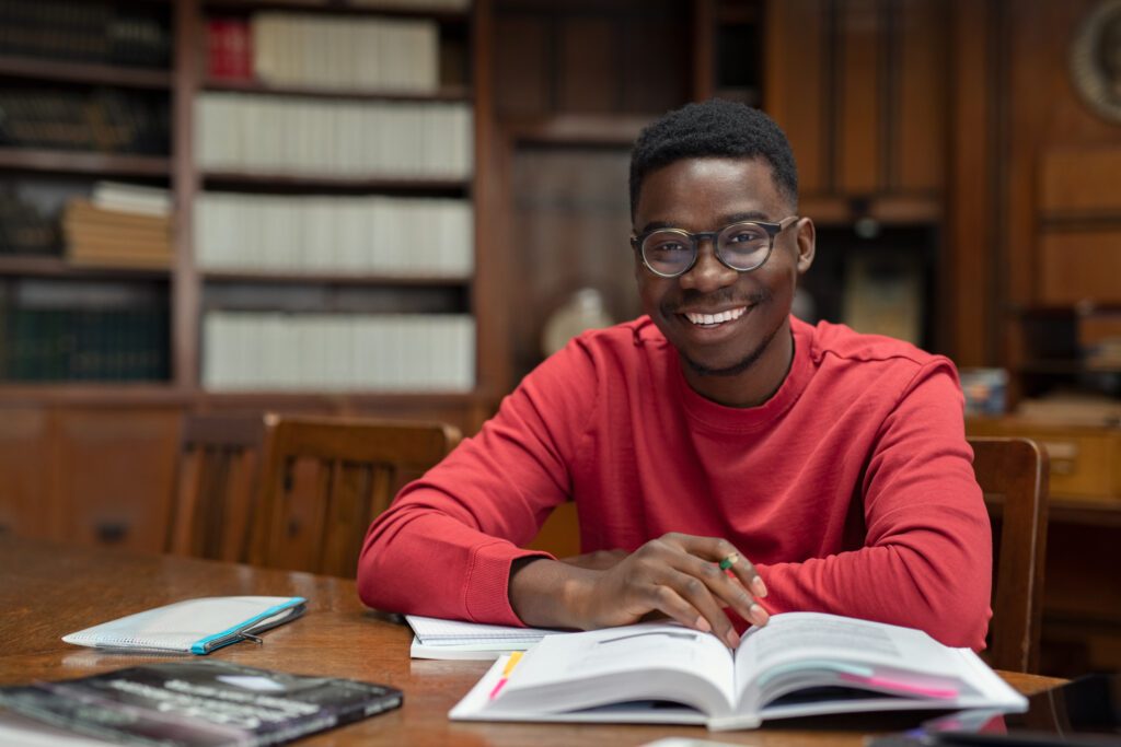 student smiling while studying in library
