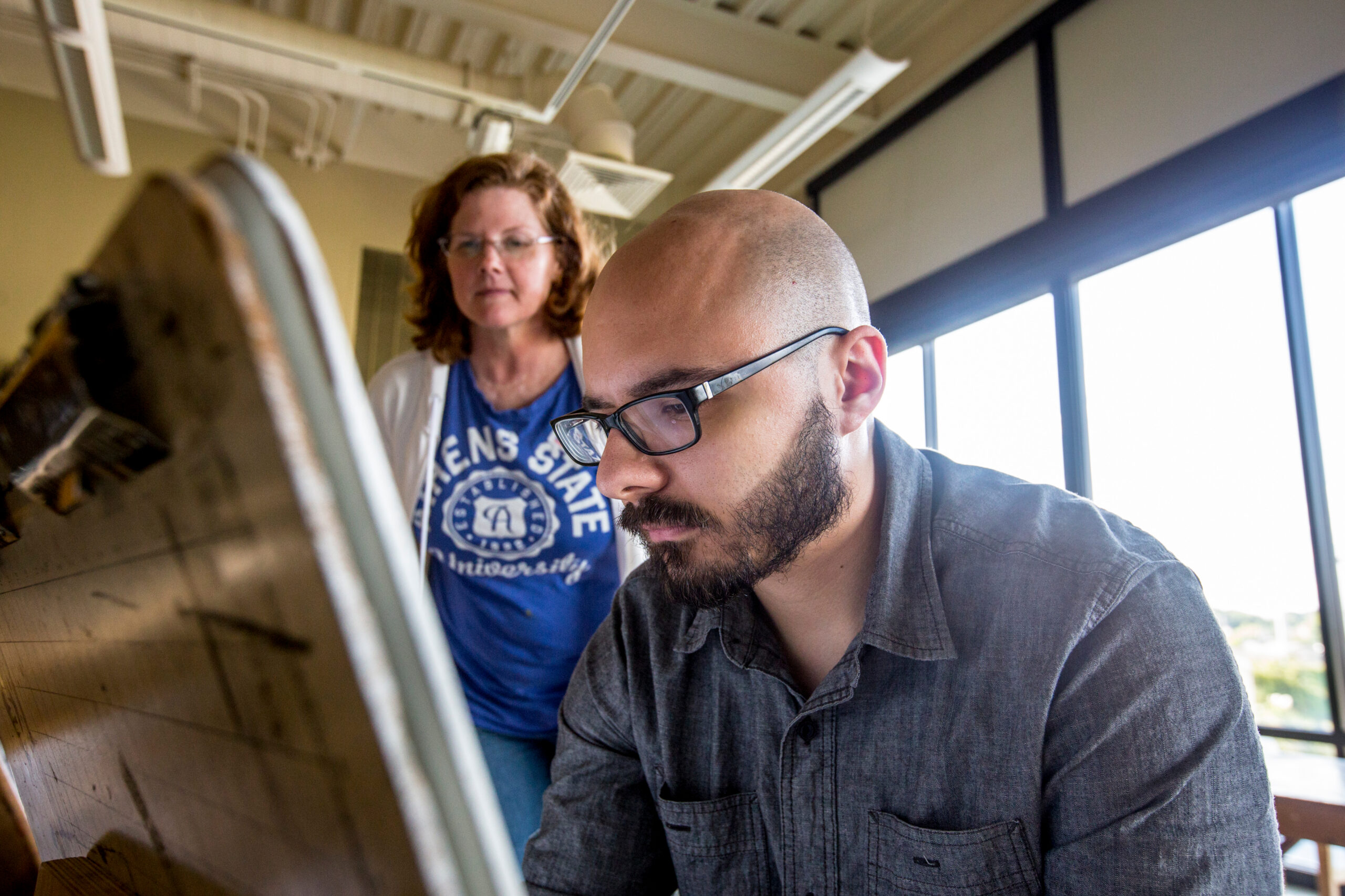 Faculty works with art students