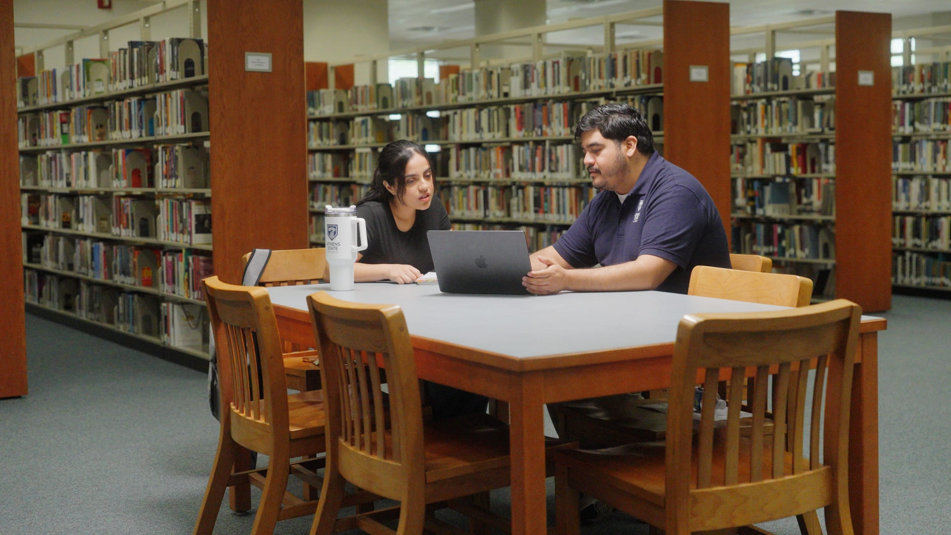 Students meeting at table in library