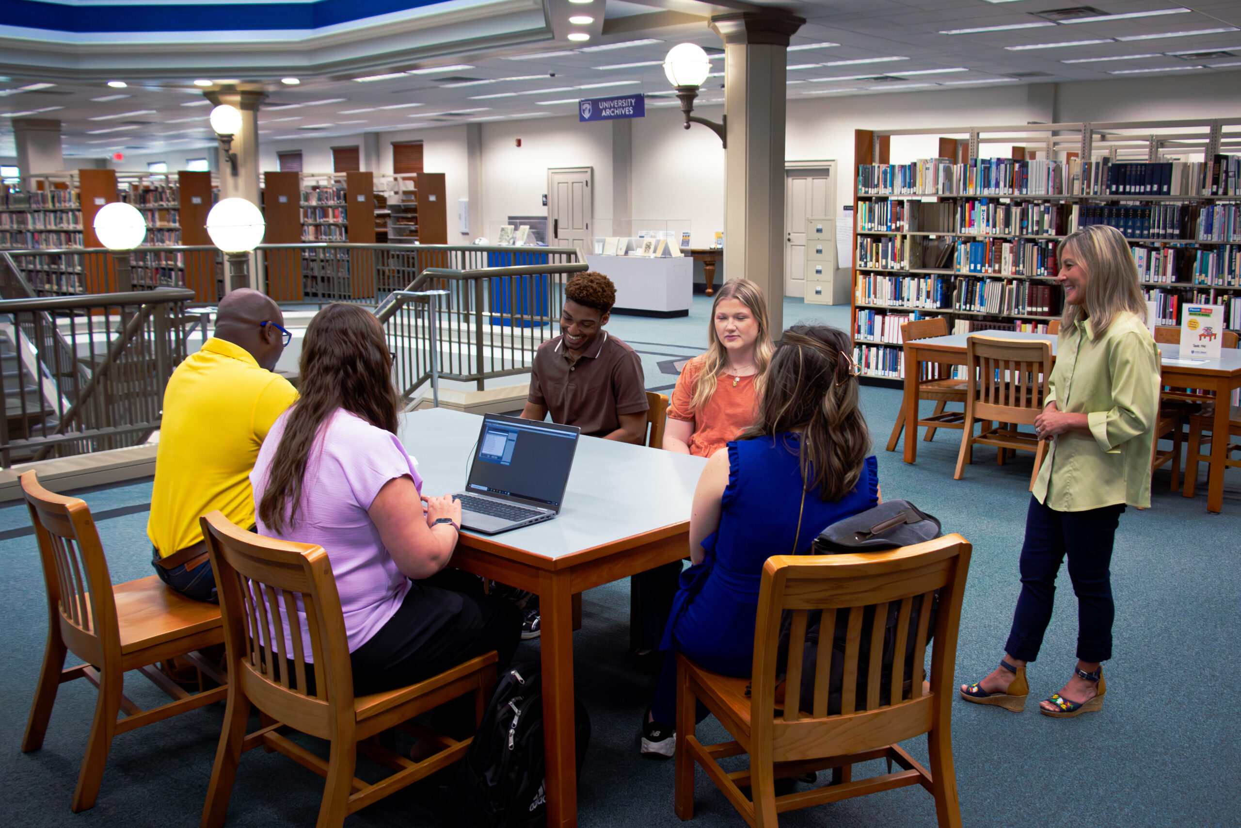 Students and faculty meeting in the library