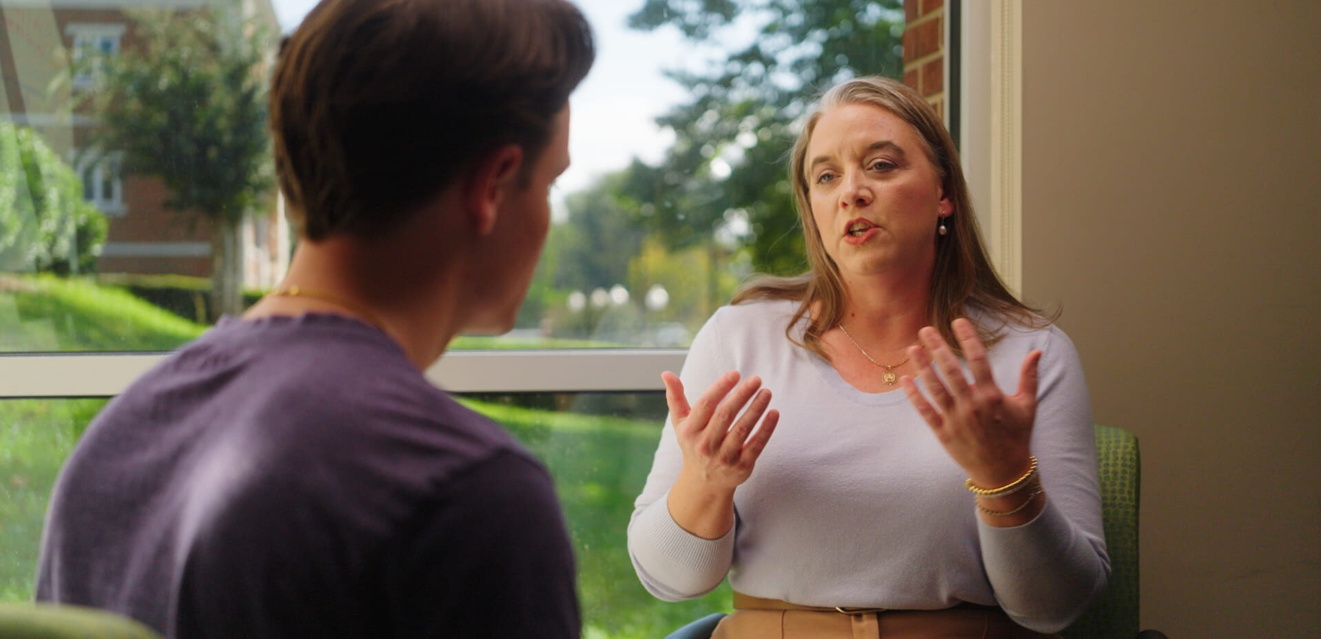 advisor and students having a conversation outdoors